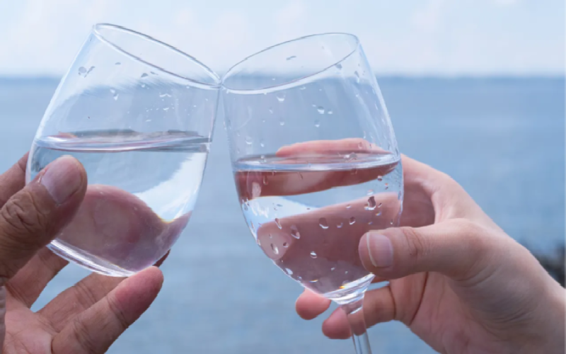 Two glass of water doing cheers